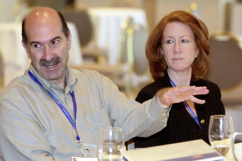 man gestures during seminar comments