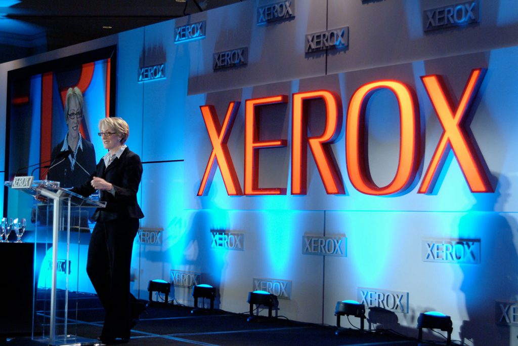 femail speaker in front of colorful conference background