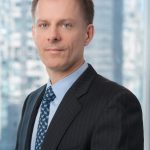 male executive in front of large window