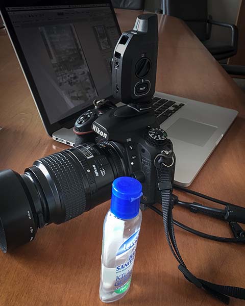 still life photo of camera, laptop computer, and hand sanitizer